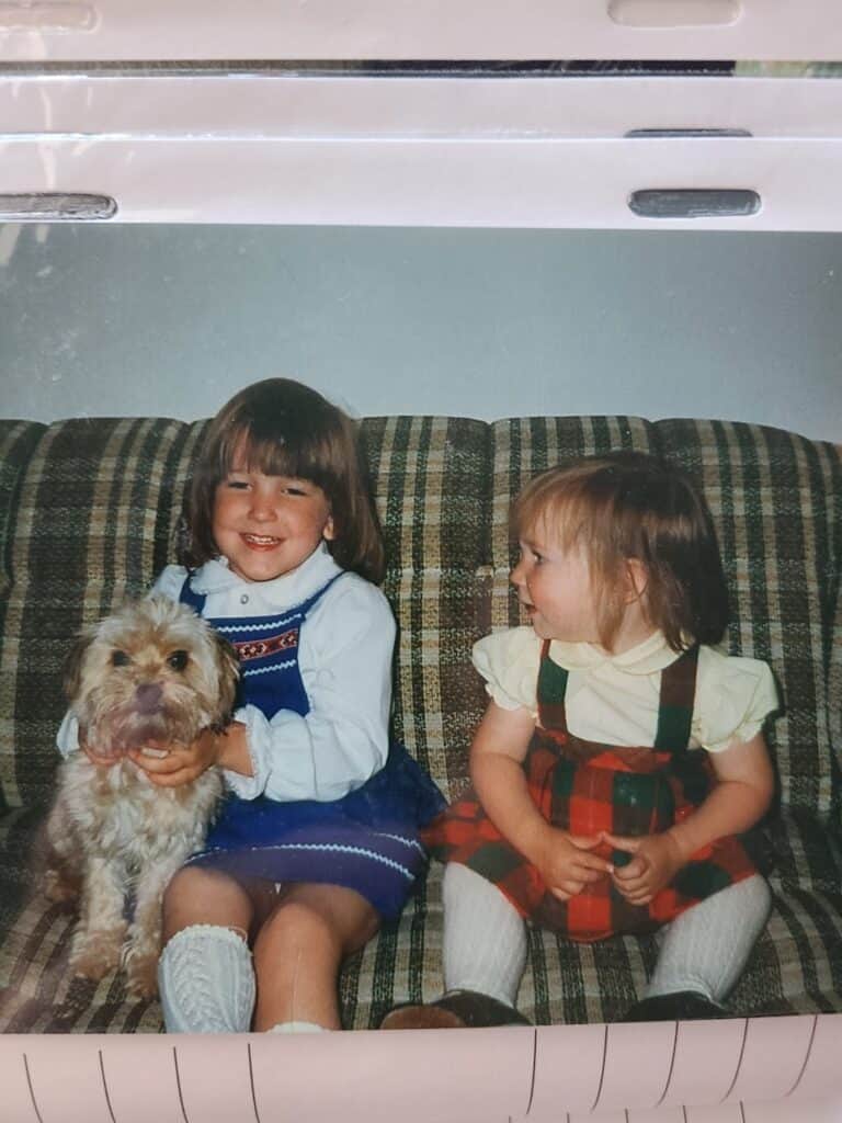 jeannine betts with her little sister and dog sitting on a couch